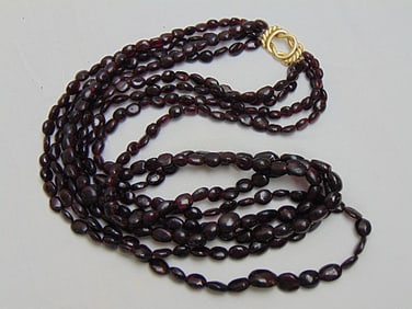 Jewelry. 18kt yellow gold triple strand amethyst beaded necklace, hallmark on clasp 750, length 12"