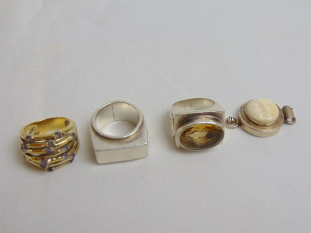 Jewelry. Sterling Modern rings & other lot to include three sterling rings & 1 sterling moon face (1 of 5)