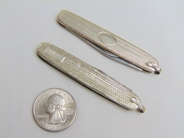 Jewelry. 2 10kt white gold pocket knives, 35.85 grams total weight, hallmark on each, stainless