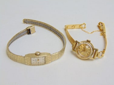 Jewelry. 2 Gold ladies wristwatches 18kt & 14k to include 18kt test Omega face, band made in Germany