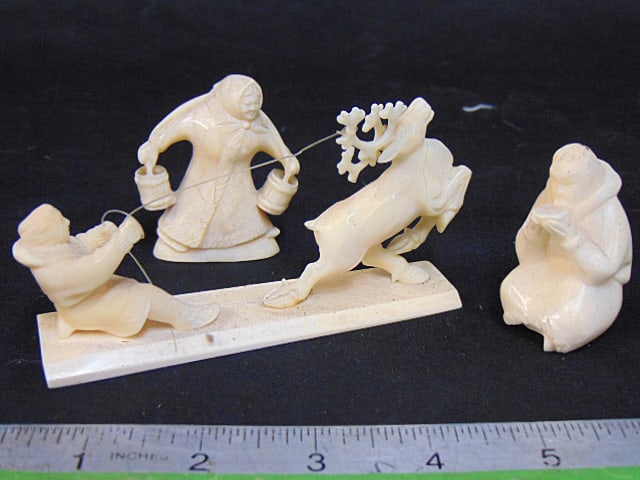3 Inuit bone carvings, figure drinking from bowl, figure carrying pails & figure with reindeer.: 3 Inuit bone carvings, figure drinking from bowl, figure carrying pails & figure with reindeer.