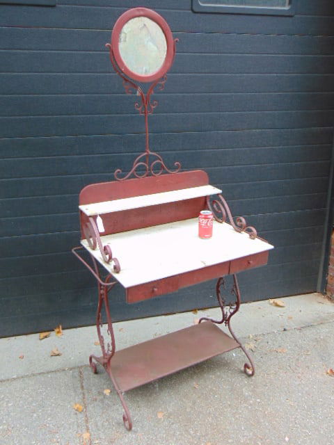 Painted iron washstand with small round mirror, decorative base, stand is 33" wide, 20.5" deep,: Painted iron washstand with small round mirror, decorative base, stand is 33" wide, 20.5" deep, height is 68."