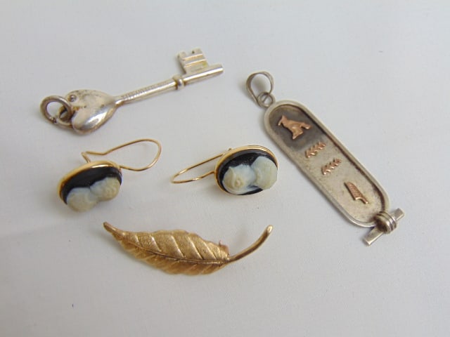 Jewelry lot to include 14kt hallmark cameo earrings & sterling Tiffany & Co. small key, cartouche: Jewelry lot to include 14kt hallmark cameo earrings & sterling Tiffany & Co. small key, cartouche pendant sterling w/ gold accent figures, & 14k tested yellow gold leaf pin, 2.20 grams
