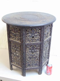 Moroccan carved side table with carved top, decorated with camels, intricately carved grape leaf pat