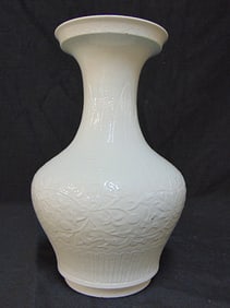 Chinese porcelain vase in white, with raised floral & leaf design, unsigned, vase is 12" tall, 7"