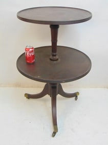 Round 19th century two tier mahogany stand, height is 33.5", diameter lower shelf is 22.5"