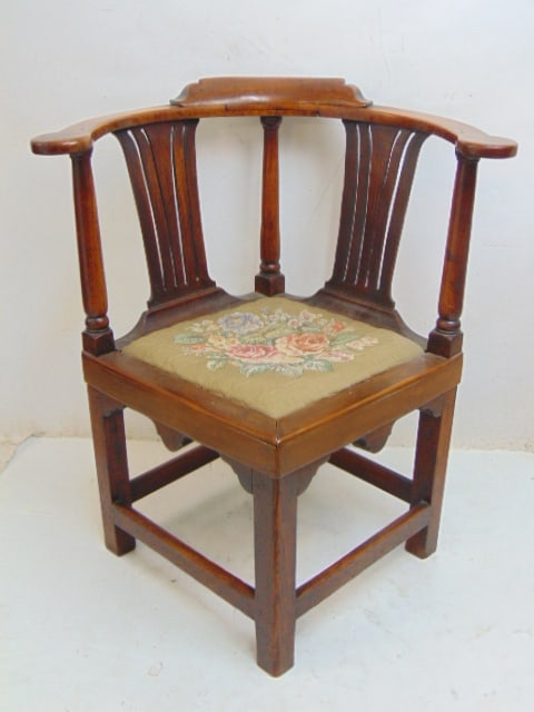 Antique corner chair with embroidered seat.: Antique corner chair with embroidered seat.