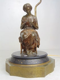 Figural bronze lamp base, on slate & brass base, no shade, showing a young lady embroidering,
