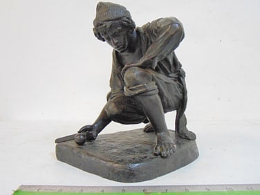 Bronze, man with tool & ball, unsigned, crouched figure with wool cap, textured patinated base,