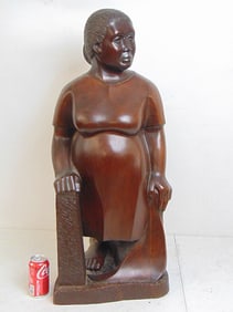 Large wood carved figure of a woman by Rubin Medina, woman leaning on pillar, post, height is 34.5"