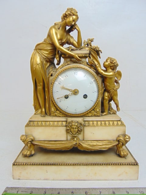 Bronze & marble figural mantle clock, lady with putti, gilt bronze & white marble, enameled face,: Bronze & marble figural mantle clock, lady with putti, 19th. ] Century gilt bronze & white marble, enameled face, with key & pendulum, clock is 10.5" wide, 5 5/8" deep, height is 14.25"