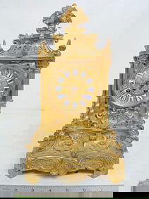 Ornate bronze mantle clock signed Norman, elaborate design with enameled numerals, clock is 12" tall