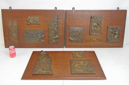 3 oak panels with applied bronze plaques, two panels hold 4 plaques, one holds 3, panels are 18.5"