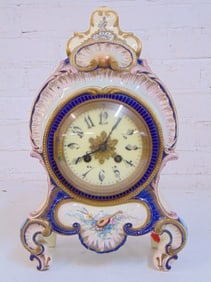 Porcelain mantle clock, decorated with flowers, marked France, clock is 13.5" tall, width is 8 3/8",