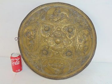 Brass shield with various decorations, animals, people fighting, diameter is 18.75"