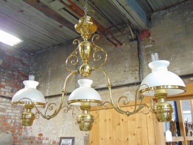 Large brass pool table fixture with milk glass shades & chimneys, one shade is cracked, fixture is