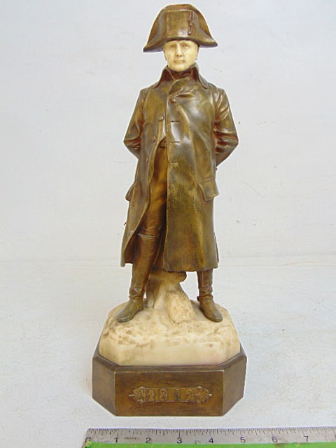 Bronze & marble statue of Napoleon in long coat with boots & spurs, hands on back, "1812", height is: Bronze & marble statue of Napoleon in long coat with boots & spurs, hands on back, "1812", height is 15"