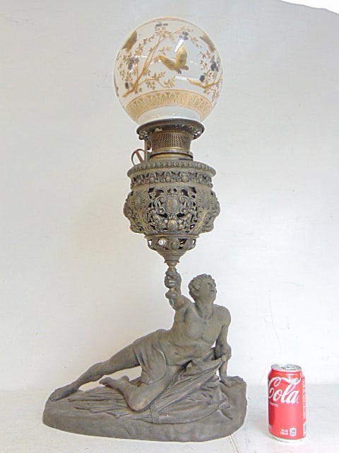 Spelter figural lamp, "Soldat Spartiate", with decorative glass globe decorated with gilt: Spelter figural lamp, "Soldat Spartiate", with decorative glass globe decorated with gilt bufferflies, base is 17" wide, 6.75" deep. Update, we found a small crack at the top of the shade, extending a