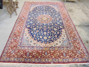 Persian roomsize carpet, silk wool combo, in red with blue center, rug is 11'7" by 7'