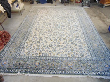 Roomsize floral carpet in light colors, white center with light blue border, good condition, rug is