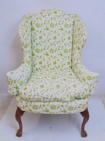 Upholstered wing chair with carved wood legs with ball & claw feet, green on white upholstery, chair