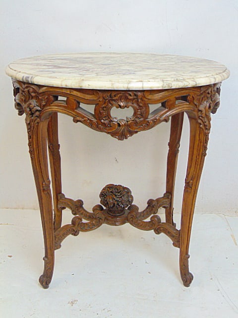 Marble top table with ornately carved wood base, carved fruit basket on carved cross stretcher base,: Marble top table with ornately carved wood base, carved fruit basket on carved cross stretcher base, table is 29.5" by 23.5", height is 31"