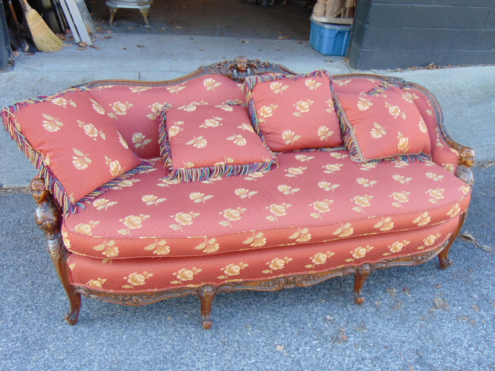 Upholstered sofa with figural carved frame, female carved figured carved in arm rest & center of bac: Upholstered sofa with figural carved frame, female carved figured carved in arm rest & center of back, carved skirt & legs, floral upholstery, good condition, sofa is 76" long, 38" deep, height is 34"