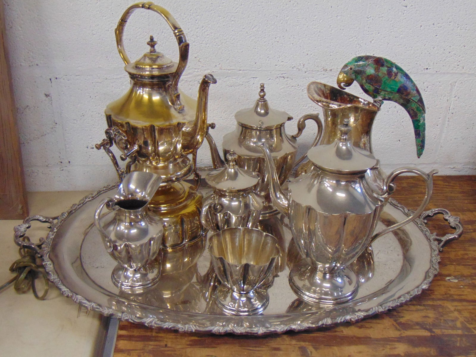 Lot Mexican silverplate, includes Pitcher with stone clad parrot handle & large 7 piece tea set on o: Lot Mexican silverplate, includes Pitcher with stone clad parrot handle & large 7 piece tea set on oval serving tray, tray is 29.5" wide, 19.5" wide, parrot pitcher is 12.25" tall