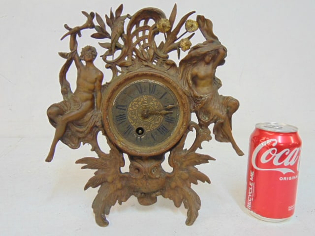 Copper relief framed mantle clock with owl base, 2 figures are flanking the face, untested, height: Copper relief framed mantle clock with owl base, 2 figures are flanking the face, untested, height is 11"