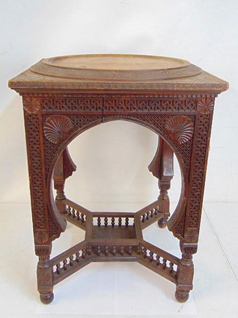 Moorish style carved wood side table, has fitted top to accommodate a dish, or charger, (missing),: Moorish style carved wood side table, has fitted top to accommodate a dish, or charger, (missing), carved with sea shells & Kufic style script, stand is 17.5" by 17.5", height is 24.25", one leg is lo
