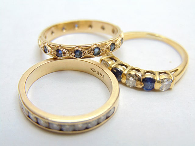 Jewelry. (3) Gold bands w/ diamonds & sapphires, diamond channel band w/ 11 inset stones, hallmark (1 of 2)