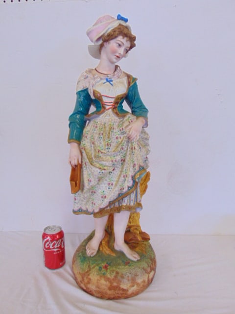 Large bisque porcelain figure of a woman holding a shoe, floral decorated dress, manner of Gille (1 of 10)