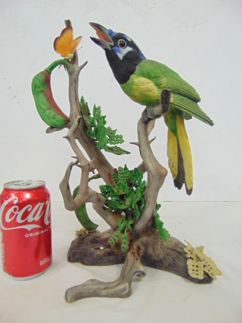 Boehm porcelain "Green Jay", number 50, limited edition bisque porcelain bird perched on branch with: Boehm porcelain "Green Jay", number 50, limited edition bisque porcelain bird perched on branch with leaves and butterfly, 10" deep, 10" wide height is 13.75", brown drip marks around leaves in center