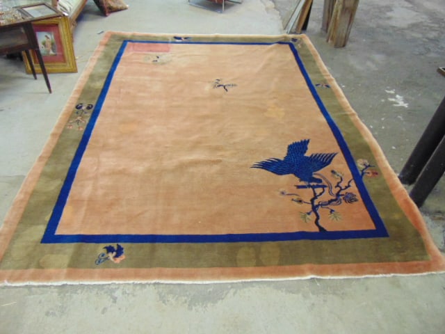 Chinese room size carpet, art deco design with bird, butterfly & floral decoration, salmon colored: Chinese room size carpet, art deco design with bird, butterfly & floral decoration, salmon colored field with blue &* brown border, good condition, rug is 11'10" by 9", has impression of a small piece
