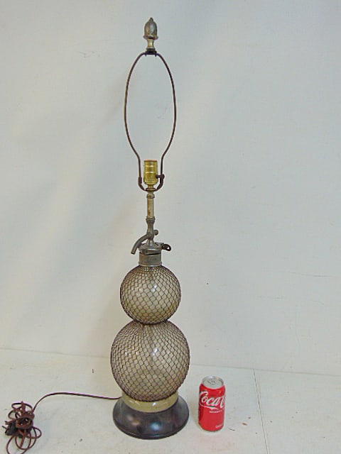 Double wire covered seltzer bottle, lamped, "The Army & Navy Co-op Scty Ltd, 38" tall (1 of 4)