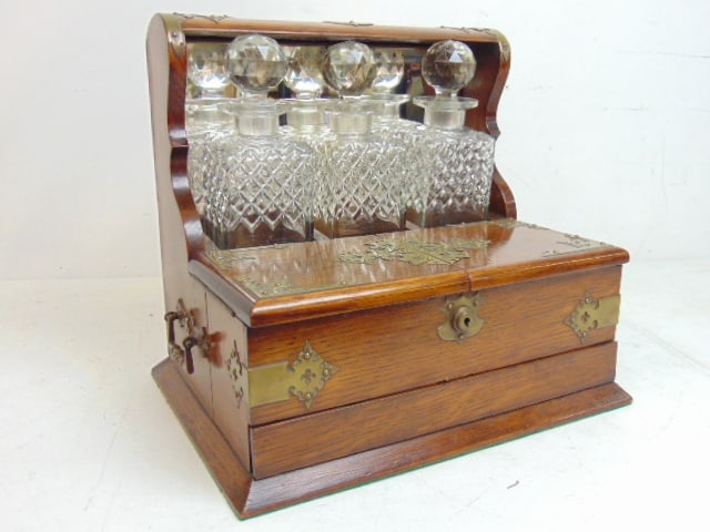 Bottle castor in oak by Bramah, London, with 3 cut glass decanters, oak cabinet with decorative (1 of 6)