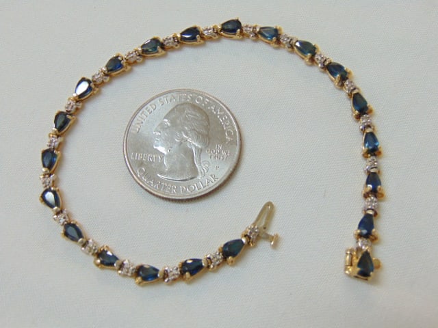 Jewelry. Gold sapphire & diamond bracelet, hallmark 14k, 8.35 grams, 7" length, 21 prong set: Jewelry. Gold sapphire & diamond bracelet, hallmark 14k, 8.35 grams, 7" length, 21 prong set sapphires w/ small diamond chip in between, good condition