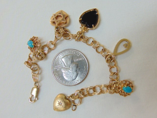 Jewelry. Vintage gold charm bracelet, hallmark on clasp 585, two charms w/ light blue stone 14kt;: Jewelry. Vintage gold charm bracelet, hallmark on clasp 585, two charms w/ light blue stone 14kt; star 14k; black onyx heart w/ diamond chips tested 14kt; open loop w/ tested diamond & tested 14kt; pu