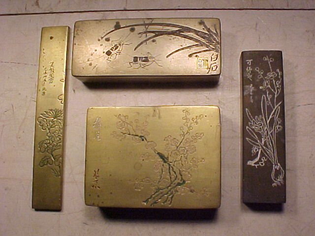 Two Chinese Brass Ink Boxes & 2 Ink Sticks: Two brass ink boxes & two ink sticks, all signed, one box decorated with blossoms, signed left side is 5.25" wide, 3 7/8 deep and 1.5" tall, brass finish is fair, showing blemishes and scratches, seco
