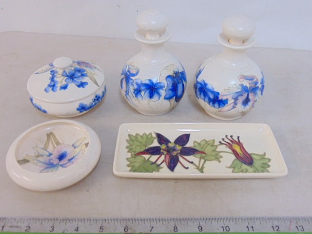 Lot Moorcroft pottery, lidded jar, small dish (chip on rim), pair small bottles with stoppers (one (1 of 9)