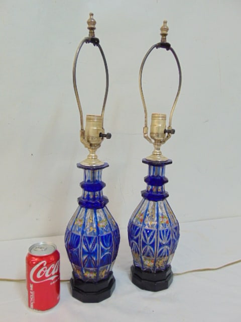 Pair Bohemian glass decanter lamps, in blue with floral decoration, some chips on rim, height lamps: Pair Bohemian glass decanter lamps, in blue with floral decoration, some chips on rim, height lamps are 22.5"