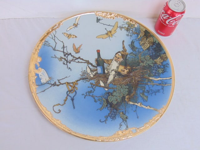 Mettlach charger by Heinrich Schlitt, Gnome in grapevine with bottles of wine, gilt edge, in good: Mettlach charger by Heinrich Schlitt, Gnome in grapevine with bottles of wine, gilt edge, in good condition, 16.25"