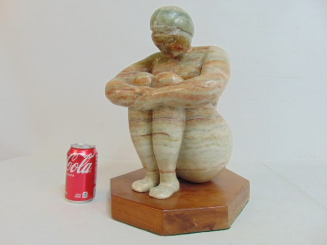 Carved marble figure, signed Anthony Gennarelli, seated woman, on wood base, height is 16 3/8",: Carved marble figure, signed Anthony Gennarelli, seated woman, on wood base, height is 16 3/8", repair to one foot.