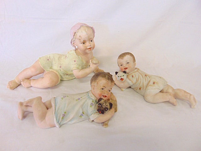 3 large bisque porcelain piano babies, two are holding puppies, largest figure is 13.5" long, need (1 of 8)