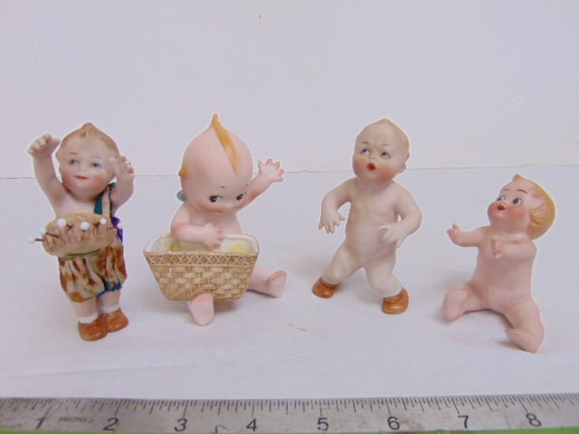 4 small porcelain Kewpie figurines, Kewpie with (repaired) basket, Kewpie pin cushion, seated & (1 of 6)