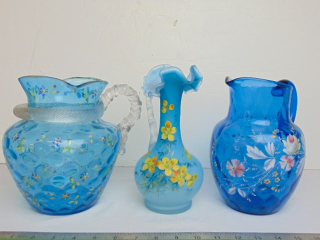 3 Victorian blue glass pitchers, vases, one with floral enameled decoration, one with applied glass: 3 Victorian blue glass pitchers, vases, one with floral enameled decoration, one with applied glass snake like handle (chipped) plus blue satin glass floral decorated pitcher, 8.5" tall