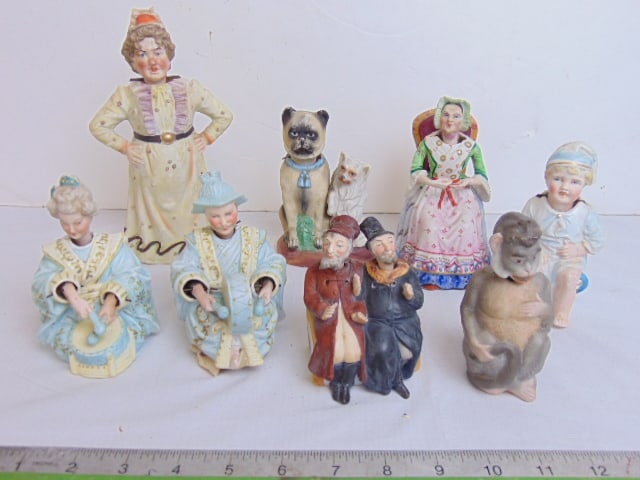 Collection of 8 bisque porcelain nodders, various figures, lady on chair, dogs, 2 men on a bench, (1 of 9)
