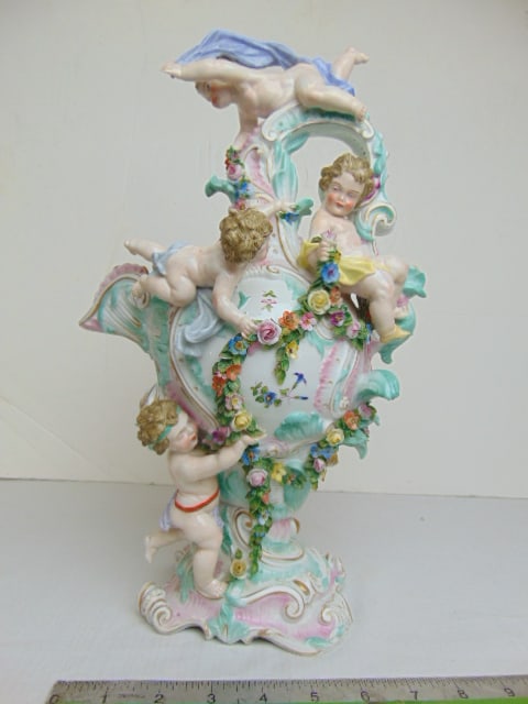 Elaborate porcelain figural pitcher, decorated with various putti, flowers, pitcher is 14.5" tall, (1 of 7)