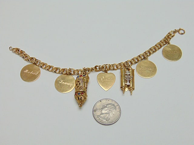 Jewelry. Vintage GOLD Judaica charm bracelet w/ charms, 38.85 grams, all 14kt, one Mezuzah scroll: Jewelry. Vintage GOLD Judaica charm bracelet w/ charms, 38.85 grams, all 14kt, one Mezuzah scroll charm w/ red & blue stones door opens & depicts a figure tested 14kt all other charms and bracelet hal