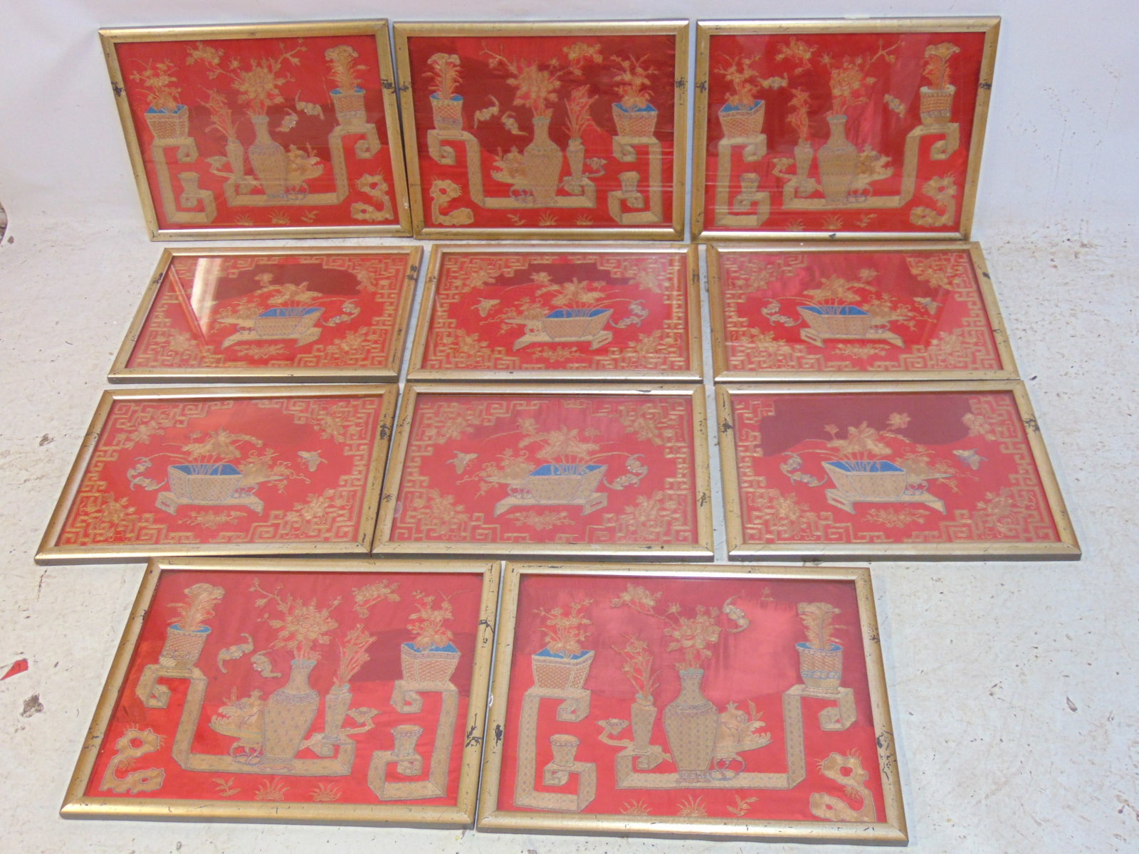 12 framed Chinese embroidered silk panels, gold thread embroidered on red ground, set 6 with planter: 12 framed Chinese embroidered silk panels, gold thread embroidered on red ground, set 6 with planter in center flanked by vases, 17.25" by 21.75" & set of 6 with single planter, 15.5" by 21"